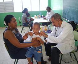 Dr. Santana, one of the many medical doctors, providing a free consultation to a child in the Bahoruco Neiba community of the Dominican Republic